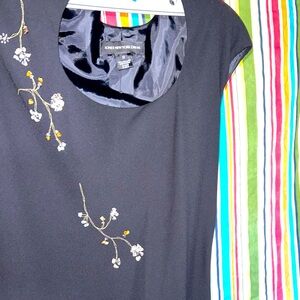 Long black dress with floral beading detail.